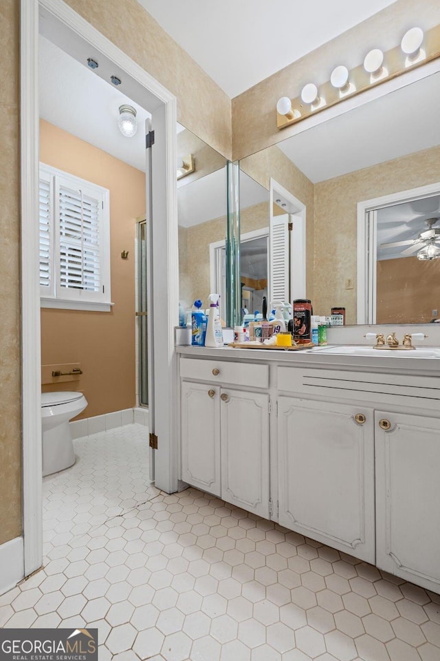681 Hampton Pl SW, Marietta, GA 30064 - bathroom featuring double vanity, toilet, tile patterned floors, baseboards, and a stall shower