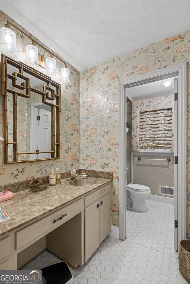 681 Hampton Pl SW, Marietta, GA 30064 - bathroom featuring vanity, toilet, a textured ceiling, wallpapered walls, and visible vents