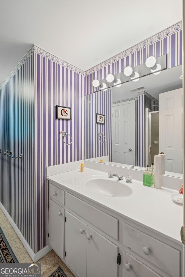 681 Hampton Pl SW, Marietta, GA 30064 - bathroom featuring wallpapered walls, a shower with shower door, and vanity