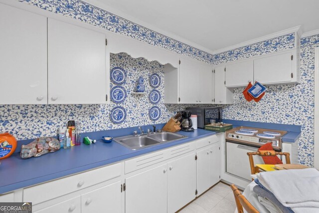 681 Hampton Pl SW, Marietta, GA 30064 - kitchen with a sink, white electric stove, wallpapered walls, and white cabinetry
