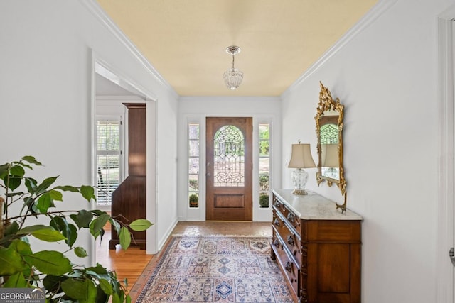 681 Hampton Pl SW, Marietta, GA 30064 - entryway featuring crown molding, baseboards, a chandelier, and light wood-type flooring