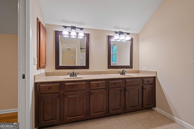 5755 Hendrix Rd, Cumming, GA 30040 - bathroom featuring baseboards, double vanity, and tile patterned floors