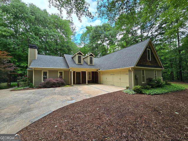 5755 Hendrix Rd, Cumming, GA 30040 - view of front of house featuring concrete driveway, a garage, roof with shingles, and a chimney