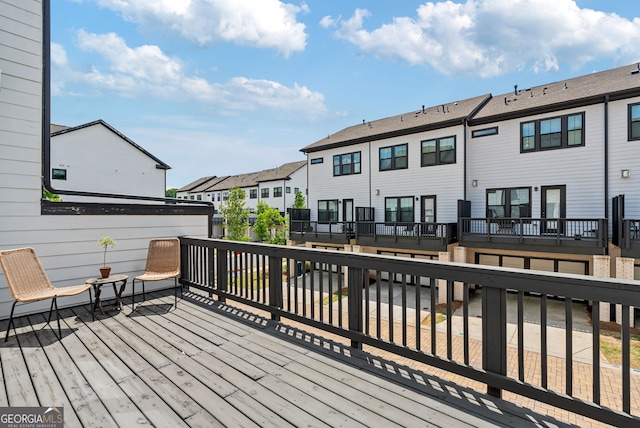 wooden deck featuring a residential view