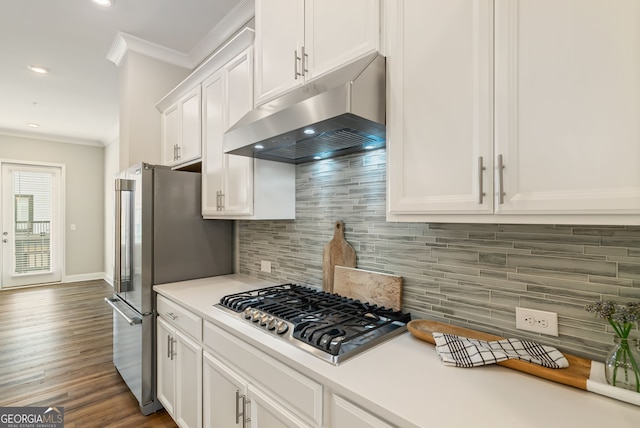 kitchen featuring crown molding, white cabinets, appliances with stainless steel finishes, light countertops, and under cabinet range hood
