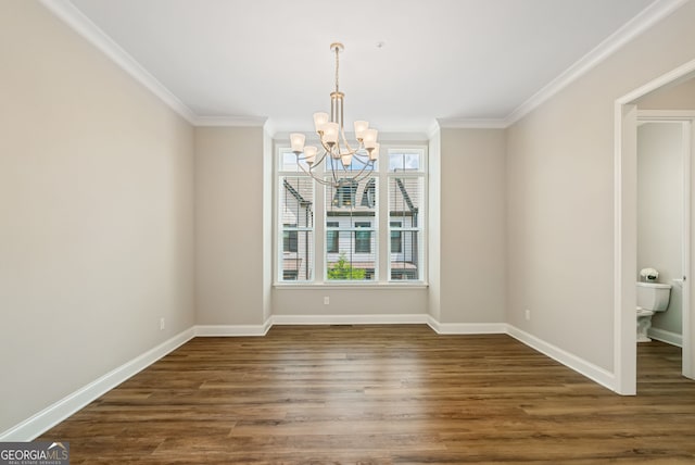 unfurnished dining area with baseboards, ornamental molding, dark wood-style floors, and a chandelier