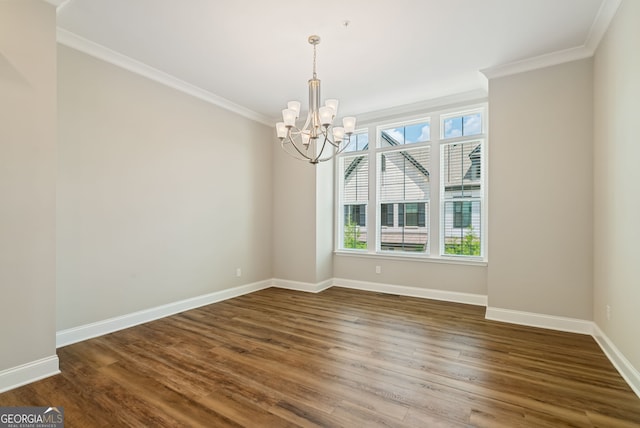 spare room with crown molding, baseboards, dark wood-style flooring, and a notable chandelier