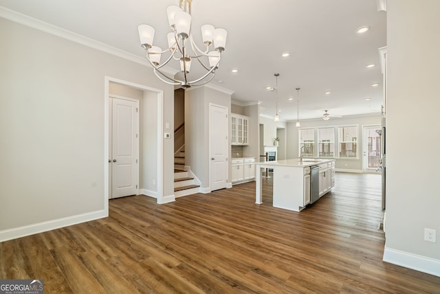 kitchen featuring a sink, dishwasher, white cabinetry, baseboards, and ornamental molding