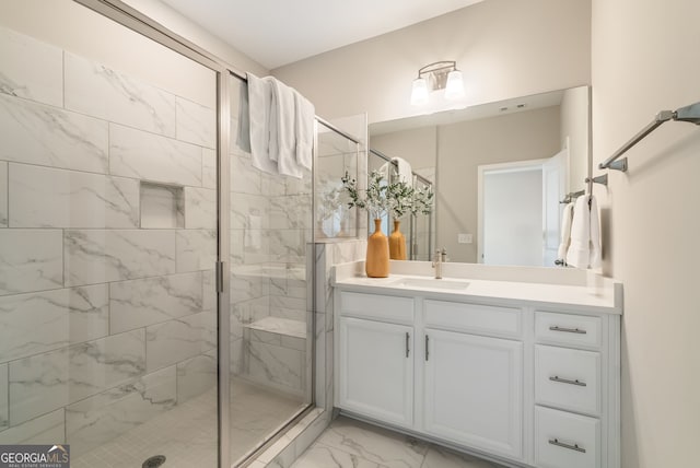 bathroom with vanity, marble finish floor, and a stall shower