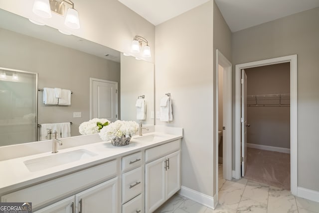 full bath featuring a sink, baseboards, and marble finish floor