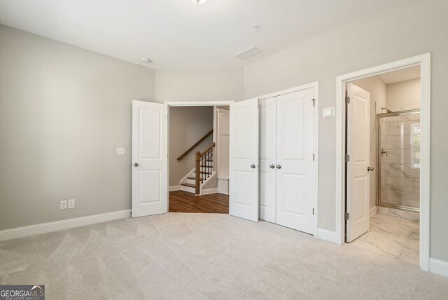 unfurnished bedroom with carpet floors, baseboards, and a closet