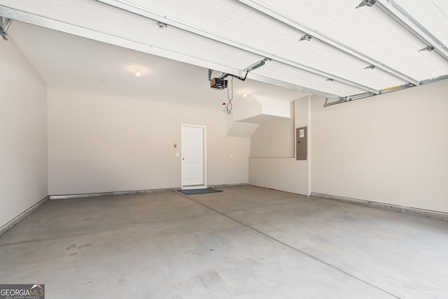 garage with a garage door opener and electric panel