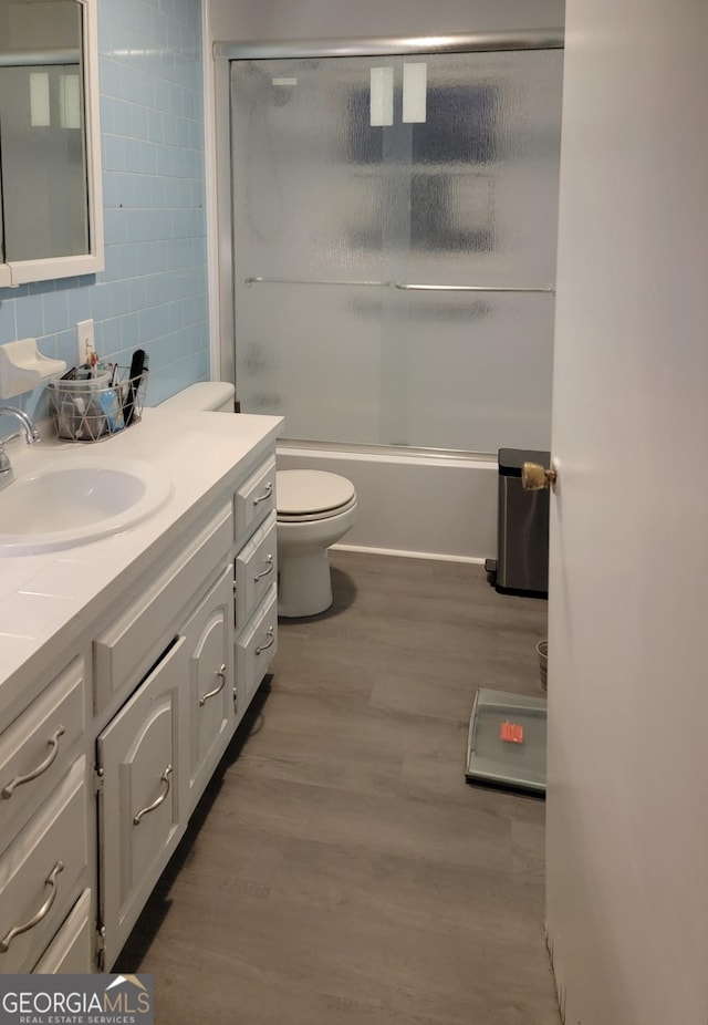 156 Brett Rd, Cleveland, GA 30528 - bathroom featuring toilet, enclosed tub / shower combo, wood finished floors, tile walls, and vanity
