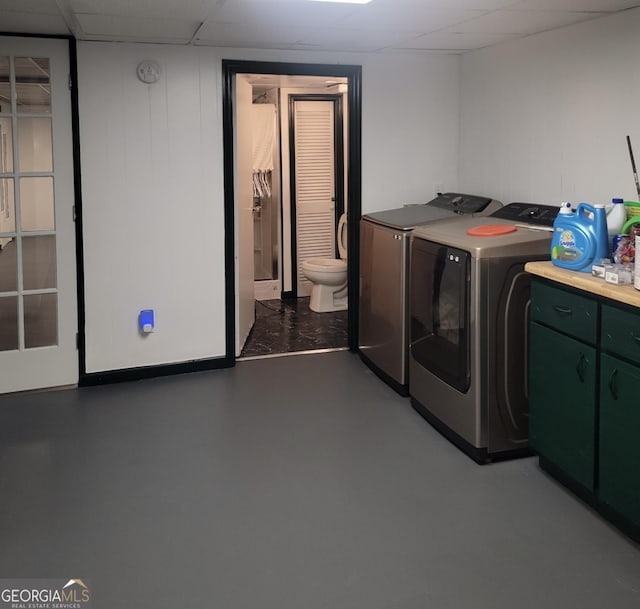 clothes washing area with independent washer and dryer and laundry area