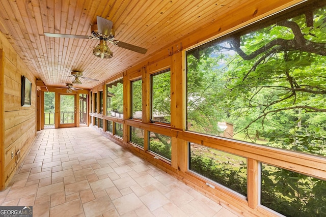 966 Wahoo Creek Rd, Murrayville, GA 30564 - unfurnished sunroom with wooden walls, stone finish floor, and a wealth of natural light