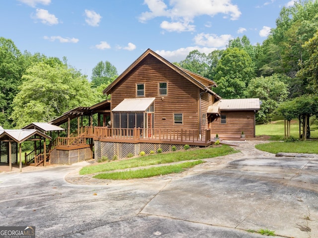 966 Wahoo Creek Rd, Murrayville, GA 30564 - view of property exterior featuring a wooden deck, a sunroom, and driveway