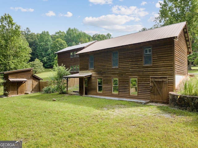 966 Wahoo Creek Rd, Murrayville, GA 30564 - rear view of house with a lawn, an outdoor structure, metal roof, and a shed