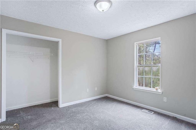 4872 Lewis Rd, Powder Springs, GA 30127 - unfurnished bedroom featuring carpet floors, a textured ceiling, baseboards, visible vents, and a closet