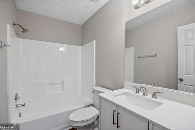 full bathroom with vanity, a textured ceiling, bathtub / shower combination, and toilet