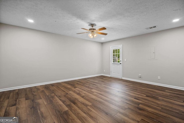 unfurnished room featuring a textured ceiling, dark wood finished floors, a ceiling fan, baseboards, and visible vents