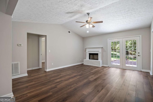 unfurnished living room with visible vents, dark wood-style flooring, a fireplace, baseboards, and ceiling fan