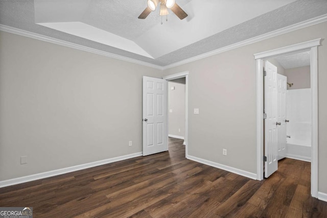 unfurnished bedroom with wood finished floors, baseboards, a textured ceiling, a tray ceiling, and a ceiling fan