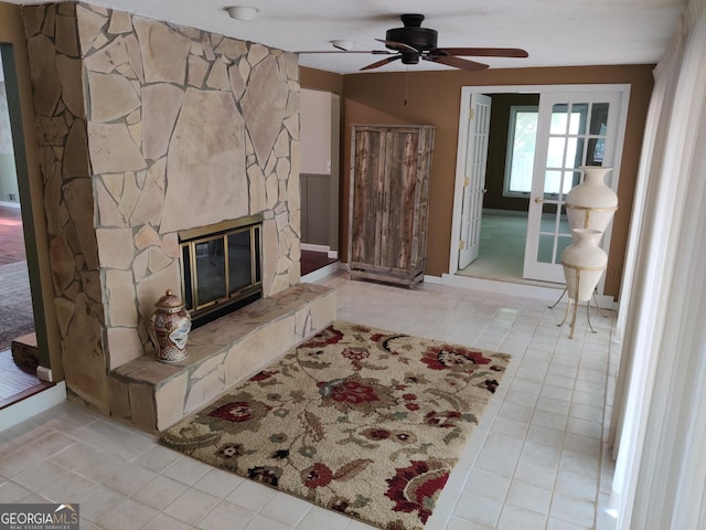living room featuring ceiling fan, tile patterned flooring, and a fireplace