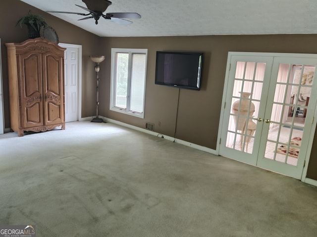 unfurnished living room featuring french doors, baseboards, and a ceiling fan