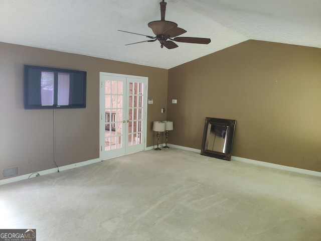 unfurnished living room with carpet flooring, ceiling fan, french doors, and lofted ceiling