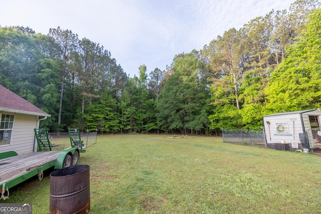 view of yard featuring fence and a wooden deck