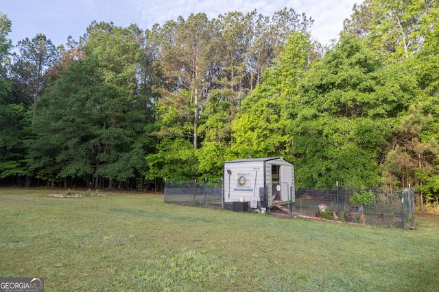 view of yard with an outdoor structure, exterior structure, and fence