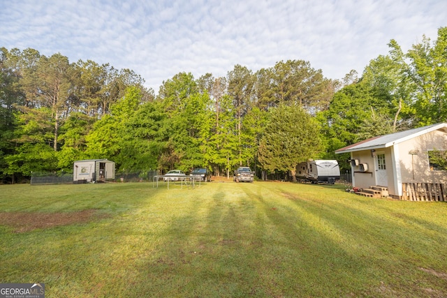 view of yard with an outbuilding, a shed, and entry steps