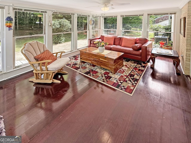 sunroom with wood-type flooring, ceiling fan, an outdoor living space, and a healthy amount of sunlight