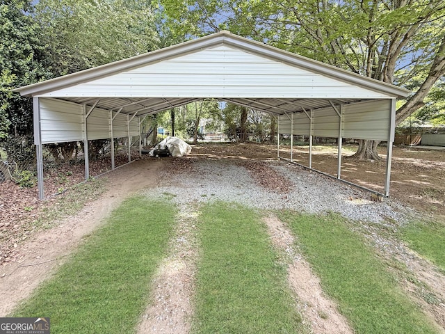 view of parking / parking lot featuring driveway and a carport