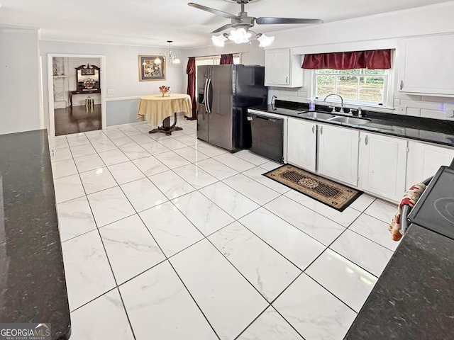 kitchen with a sink, ceiling fan with notable chandelier, black dishwasher, white cabinetry, and stainless steel refrigerator with ice dispenser