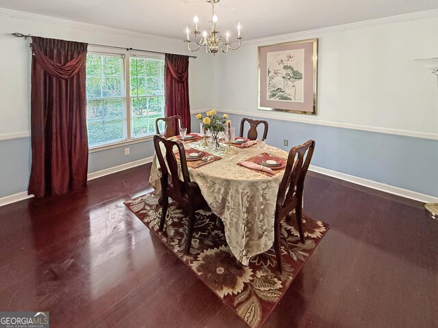dining space with crown molding, baseboards, wood finished floors, and a chandelier