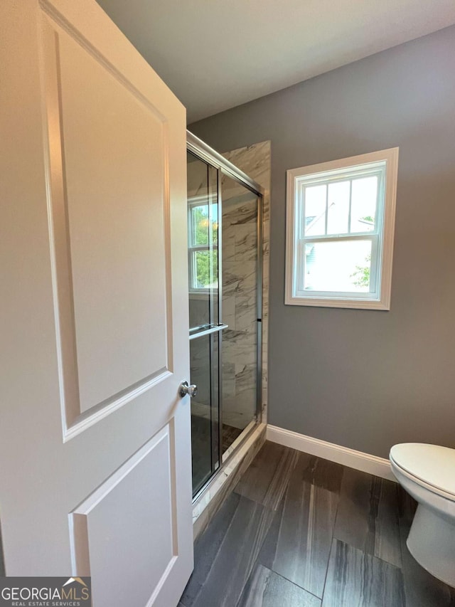154 Pope Paul Path, Dallas, GA 30132 - full bathroom featuring a stall shower, toilet, and baseboards