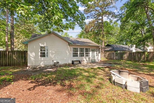 back of house featuring a fenced backyard