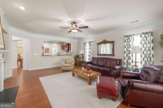 6408 Autumn Crest Ln, Hoschton, GA 30548 - living room with ornamental molding, a ceiling fan, healthy amount of natural light, wood finished floors, and baseboards
