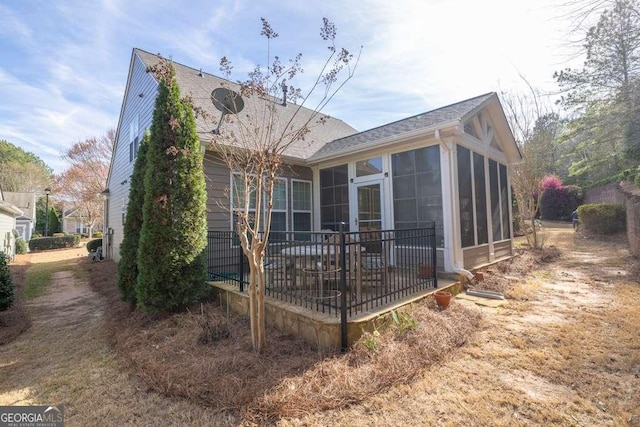 6408 Autumn Crest Ln, Hoschton, GA 30548 - back of house with a sunroom and a shingled roof