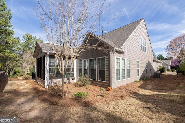 6408 Autumn Crest Ln, Hoschton, GA 30548 - rear view of house with a sunroom, roof with shingles, and central air condition unit