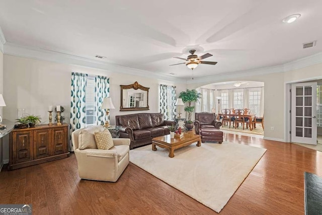 6408 Autumn Crest Ln, Hoschton, GA 30548 - living room with ornamental molding, a ceiling fan, arched walkways, and wood finished floors