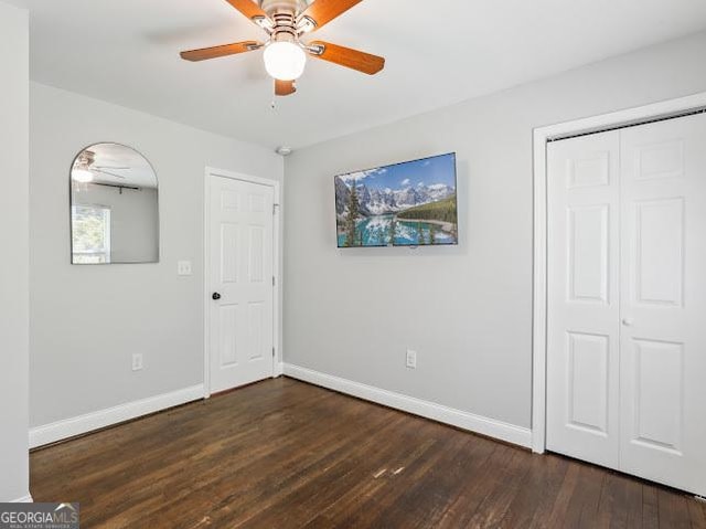 1599 Ezra Church Dr NW, Atlanta, GA 30314 - unfurnished bedroom featuring a ceiling fan, baseboards, dark wood finished floors, and a closet