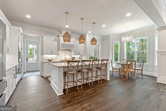 15626 Birmingham Hwy, Milton, GA 30004 - kitchen featuring a center island with sink, dark wood finished floors, plenty of natural light, and tasteful backsplash