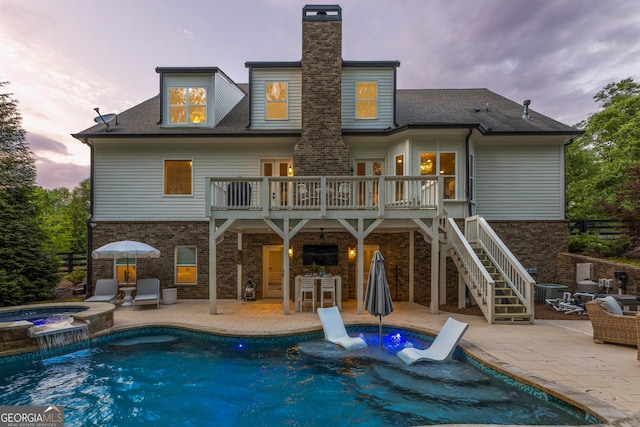15626 Birmingham Hwy, Milton, GA 30004 - back of property at dusk with a patio, brick siding, and a chimney