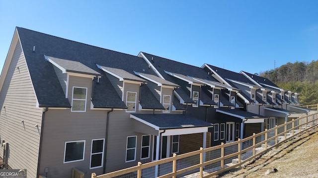 view of side of home with fence and a residential view