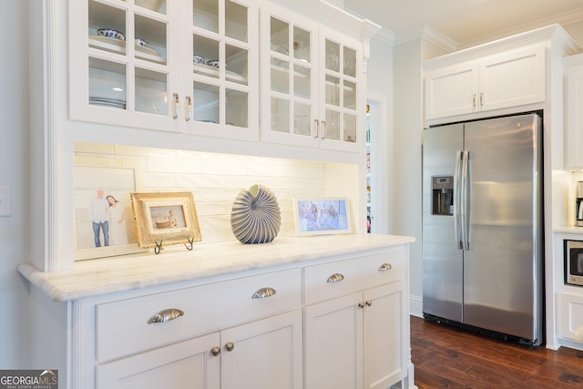 kitchen with crown molding, stainless steel appliances, white cabinetry, dark wood-style floors, and glass insert cabinets