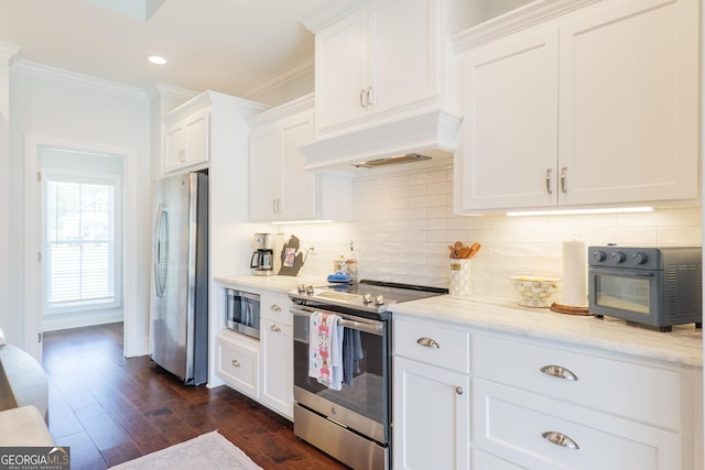 kitchen with crown molding, stainless steel appliances, white cabinetry, decorative backsplash, and custom exhaust hood