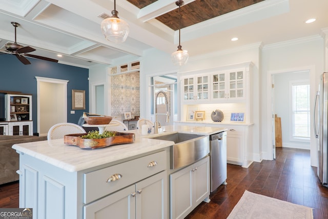 kitchen with hanging light fixtures, appliances with stainless steel finishes, a sink, a ceiling fan, and white cabinetry
