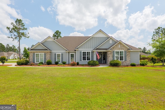 craftsman inspired home with brick siding, a front lawn, board and batten siding, and roof with shingles